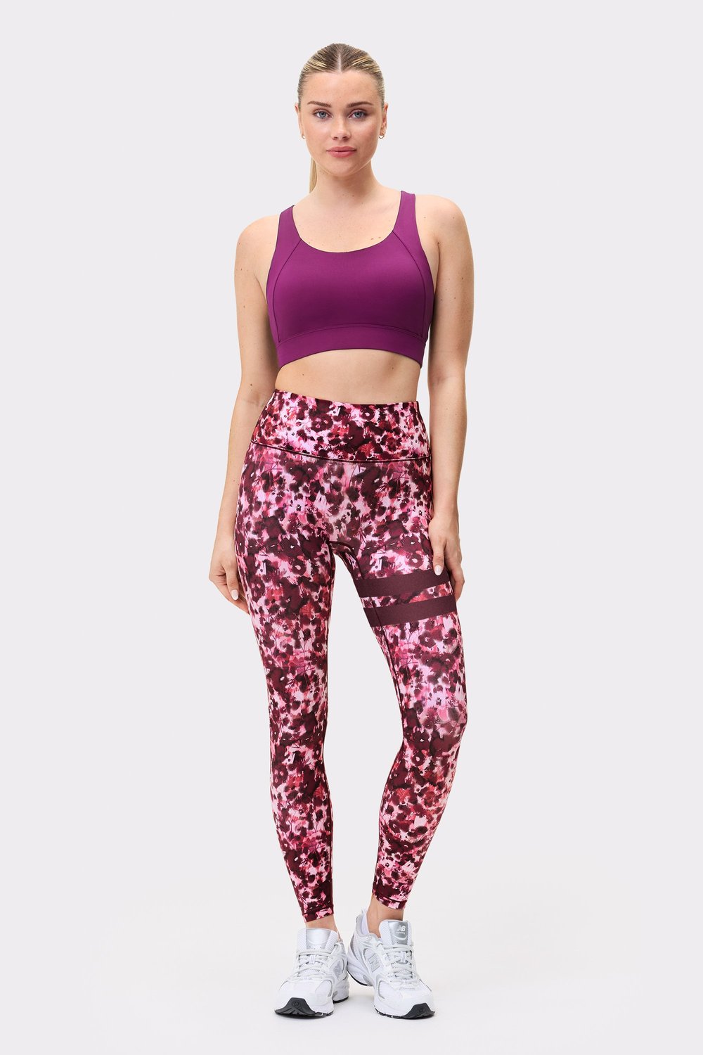Front view of a model wearing Stronger The Signature One Leggings in Autumn Petals with signature stripes on the leg.