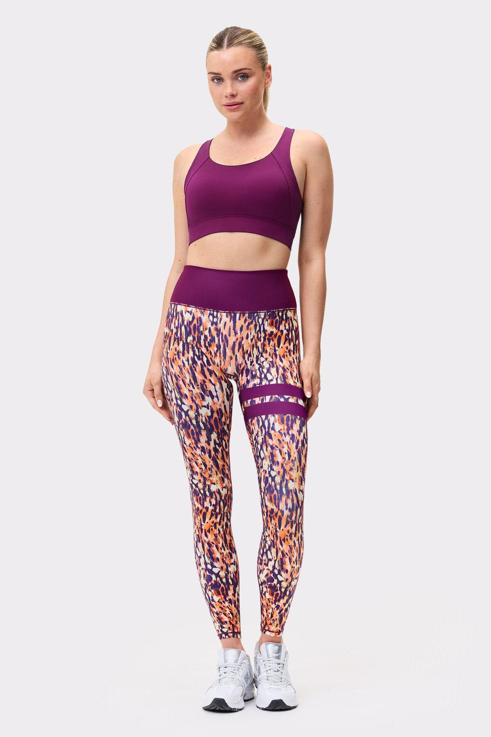 Front view of a model wearing Stronger The Signature One Leggings in Malibu Milk Print with a matching sports bra.
