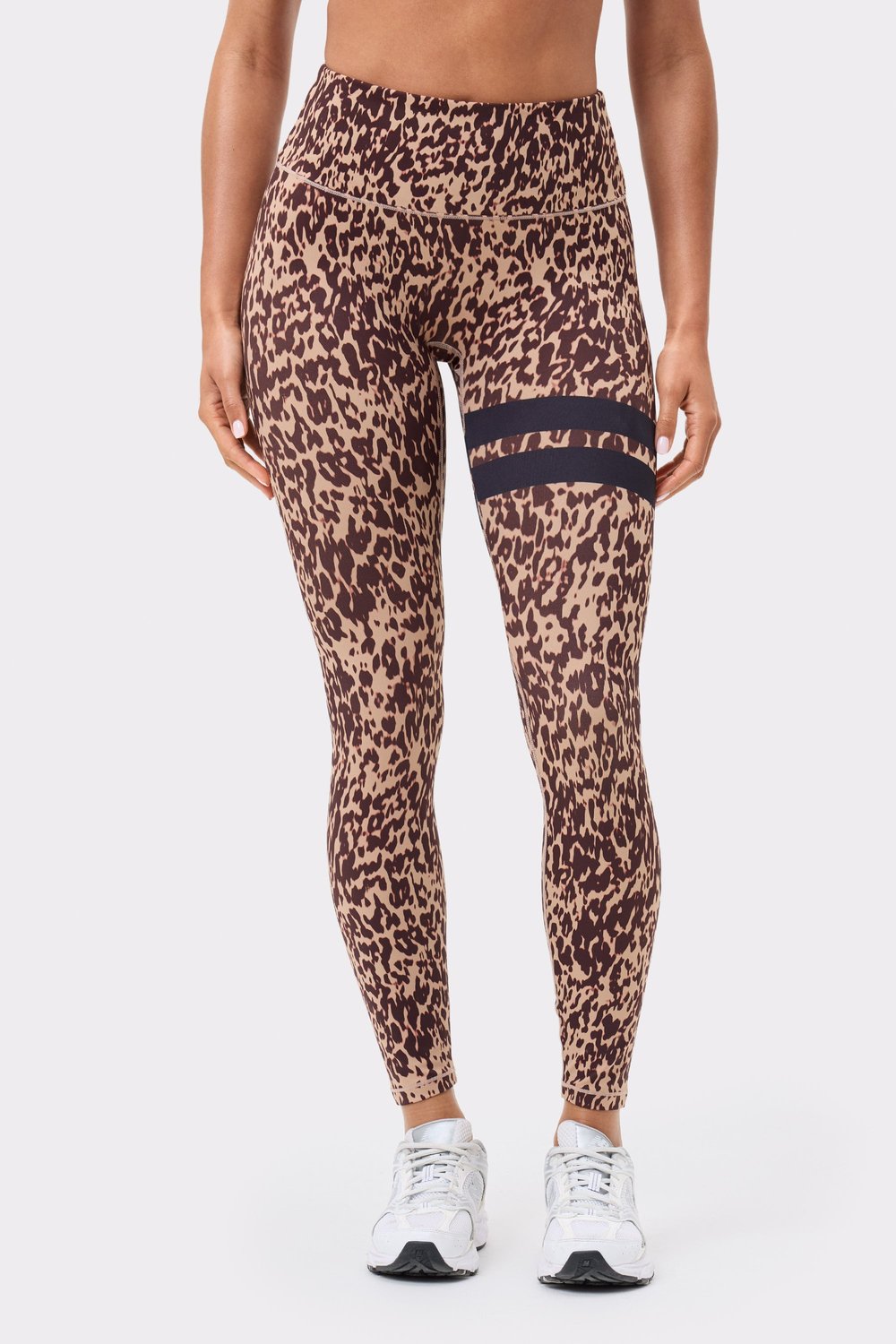 Front view of Stronger's The Signature One Leggings in light brown Leo Rush print, with black signature stripes on the thigh.