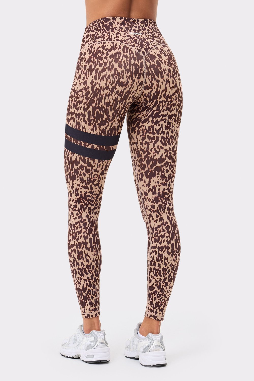 Back view of Stronger's The Signature One Leggings in light brown Leo Rush print, featuring black signature stripes.