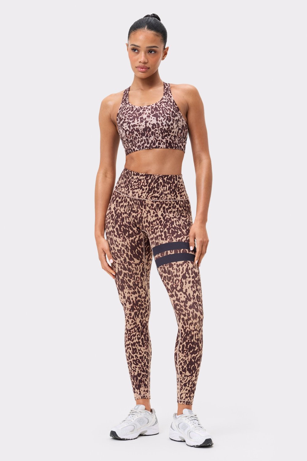Front view of Stronger's The Signature One Leggings in light brown Leo Rush print, featuring signature stripes on the thigh.