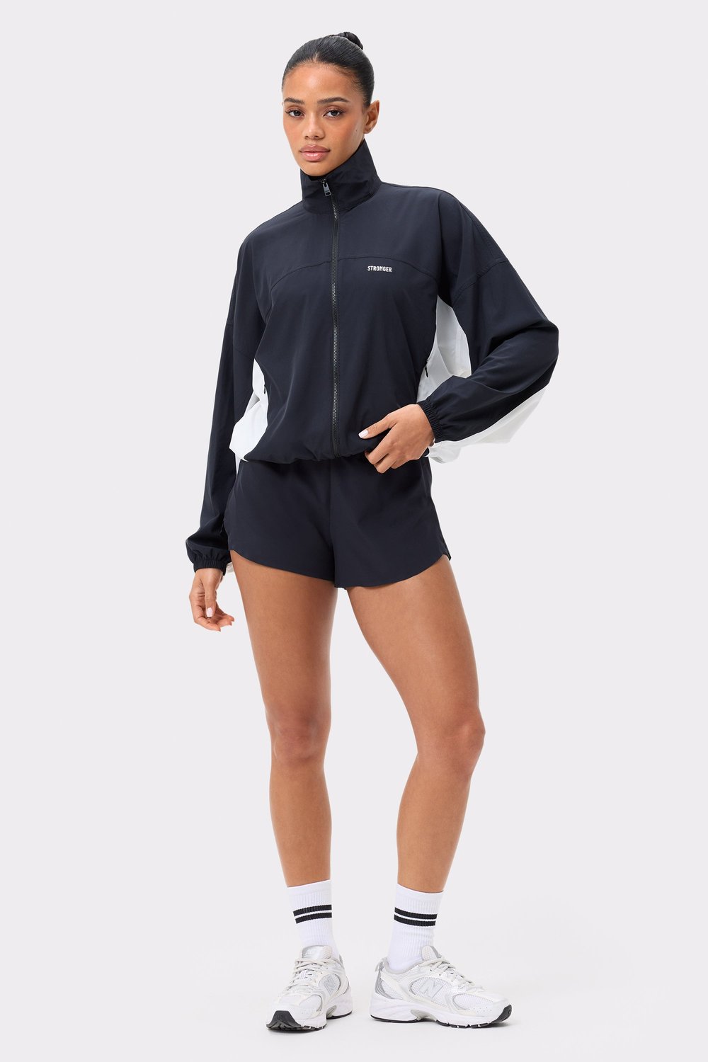 Front view of Stronger's black and white Breezy Woven Jacket, featuring a functional zip and regular fit design.