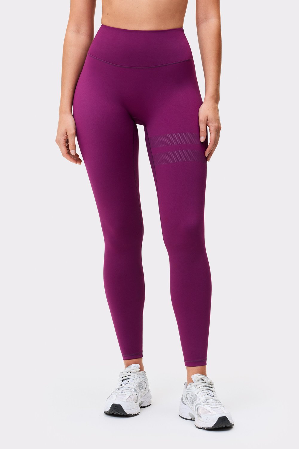 Front view of a model in The Signature One Contour Leggings in aubergine purple from stronger, showing leg details.