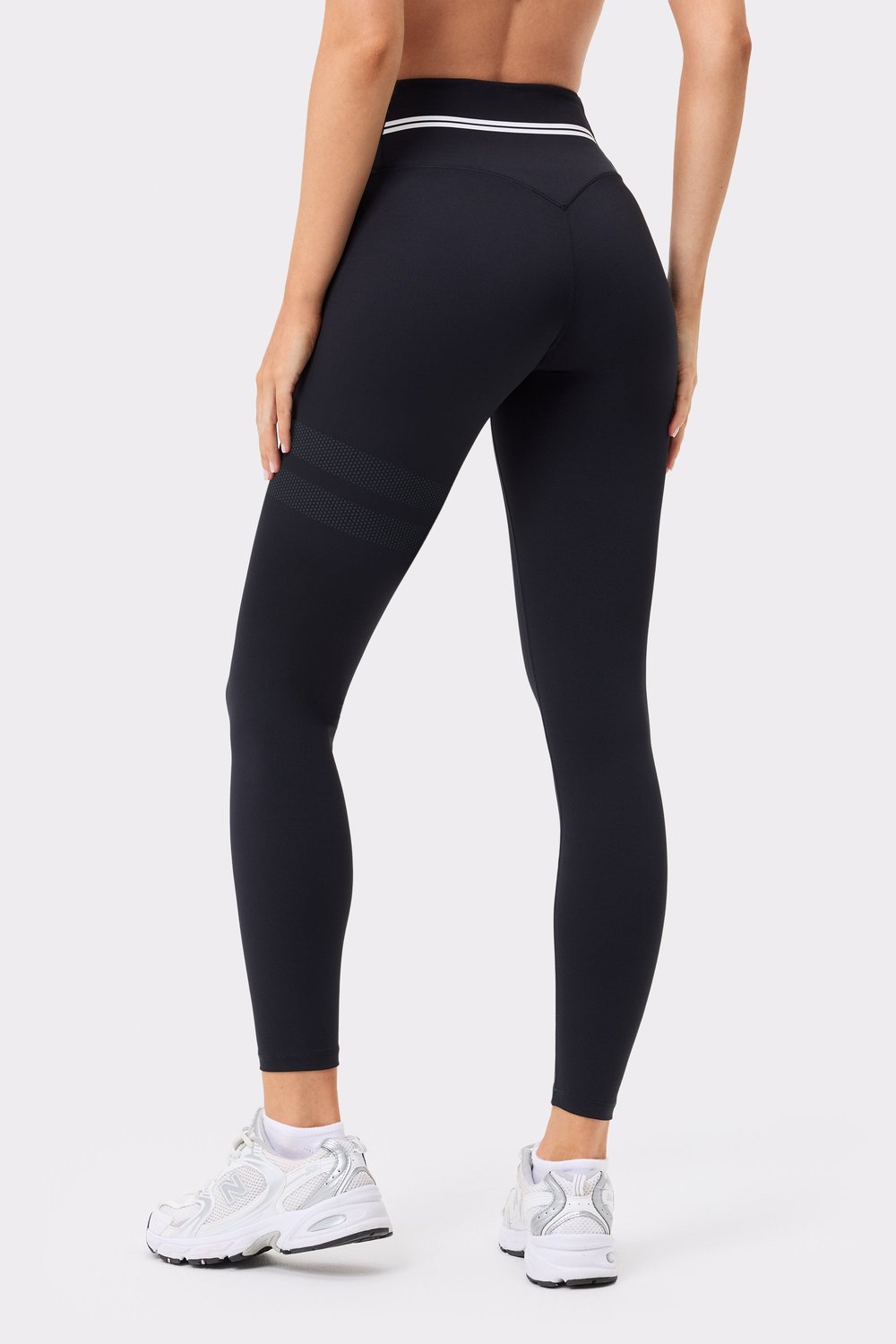 Back view of black Stronger Signature Logo Leggings, highlighting the high waist and signature stripes on the leg.