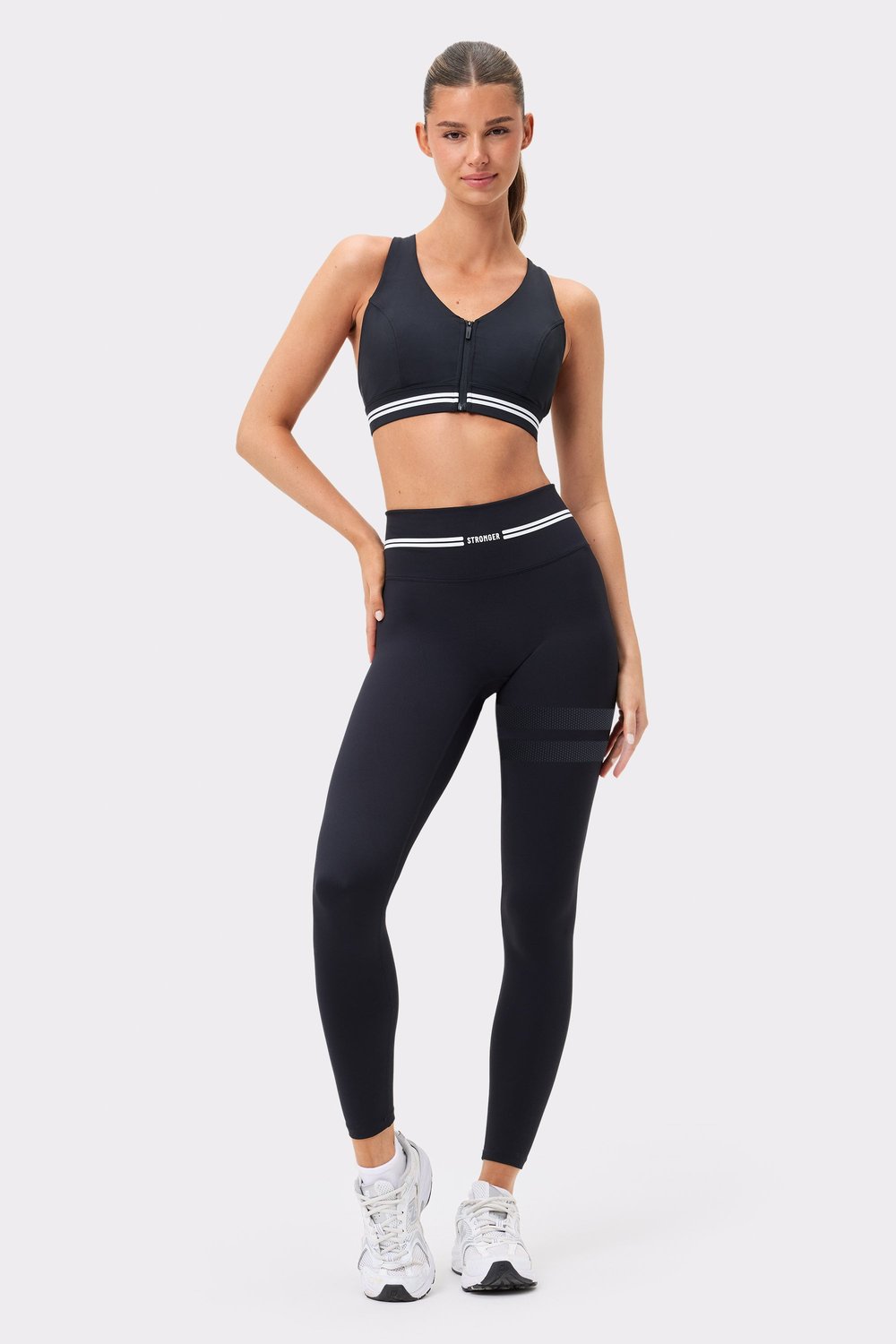 Front view of black Signature Logo Leggings by Stronger, featuring a high waist and signature stripes on the thigh.