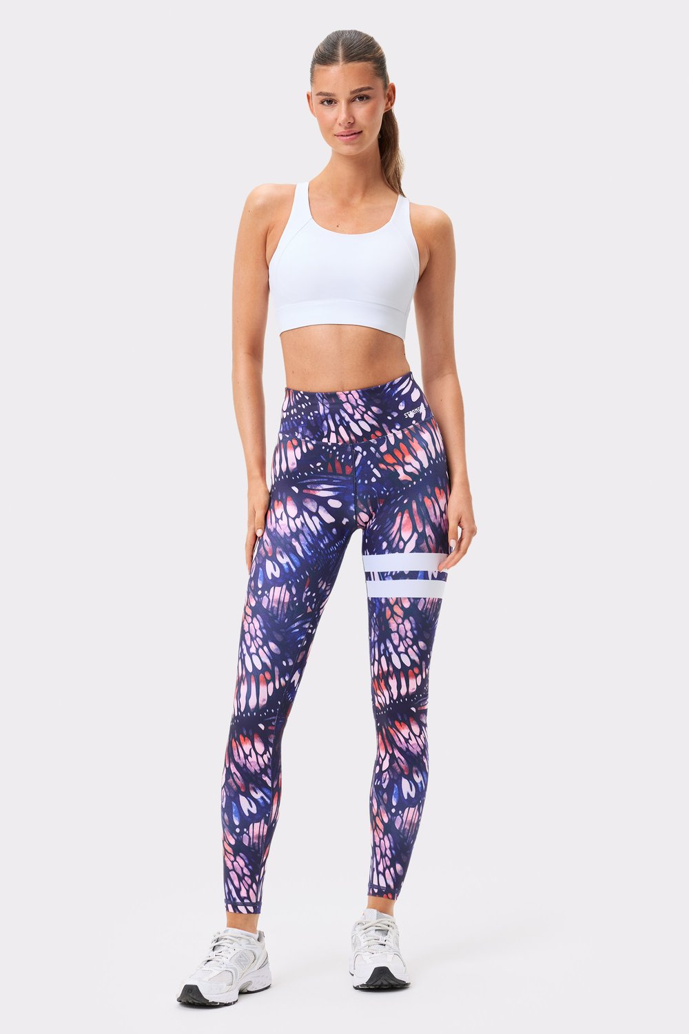 Stronger's dark pink butterfly print Explore Printed Leggings with a high waist and iconic white stripes.