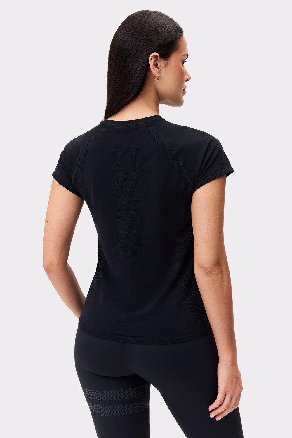 Rear view of the black Seamless Performance T-shirt by Stronger, featuring a slim fit and breathable seamless design.