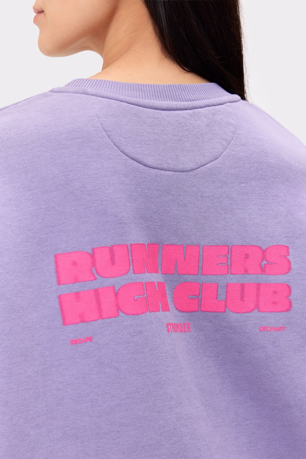 Close-up of the pink Runners High Club graphic on the back of Stronger's Vintage Violet Comfy Washed Sweatshirt.