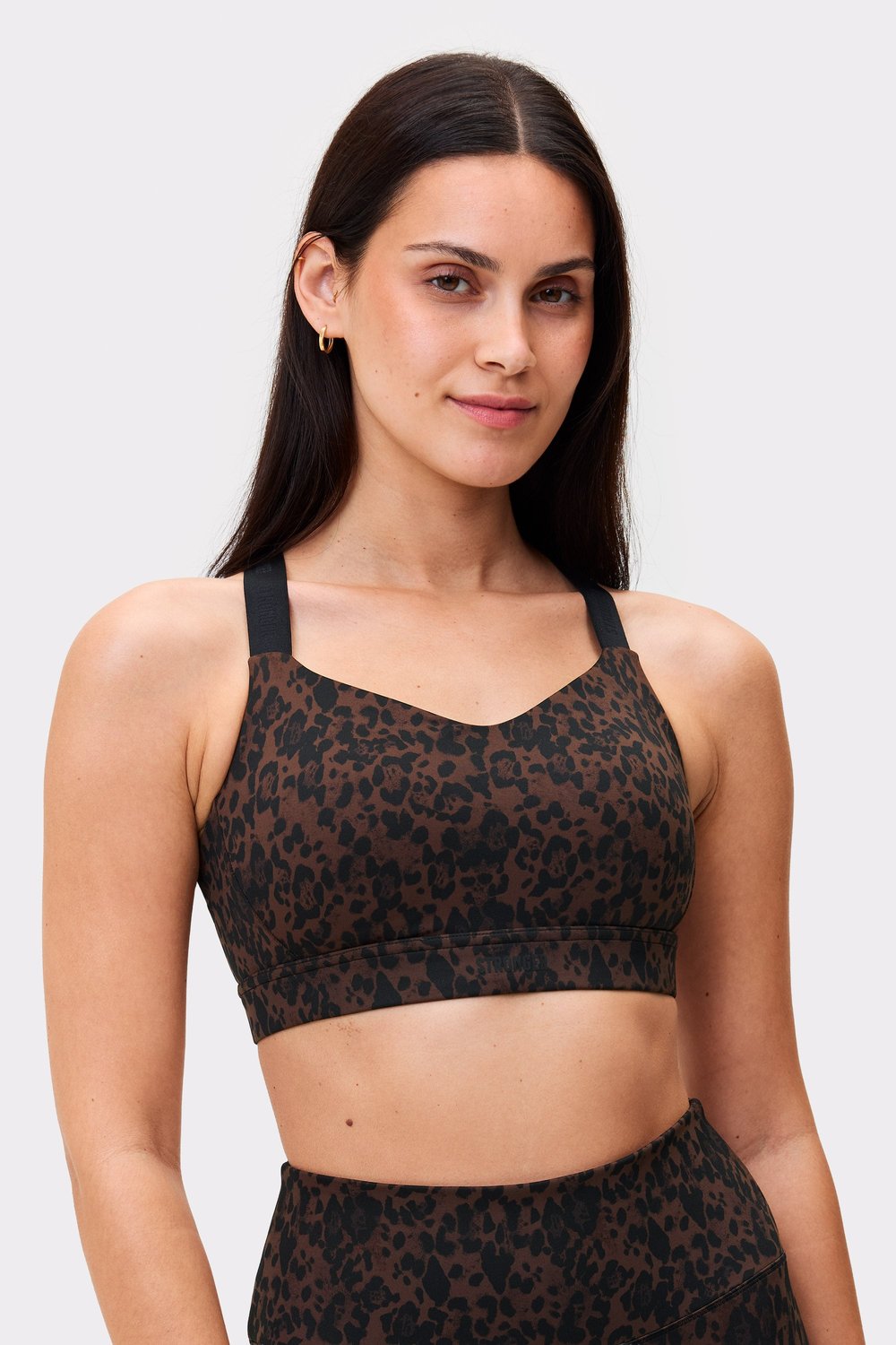 Model wearing the Power Sports Bra in Dark Leo by stronger, featuring high support and adjustable straps.