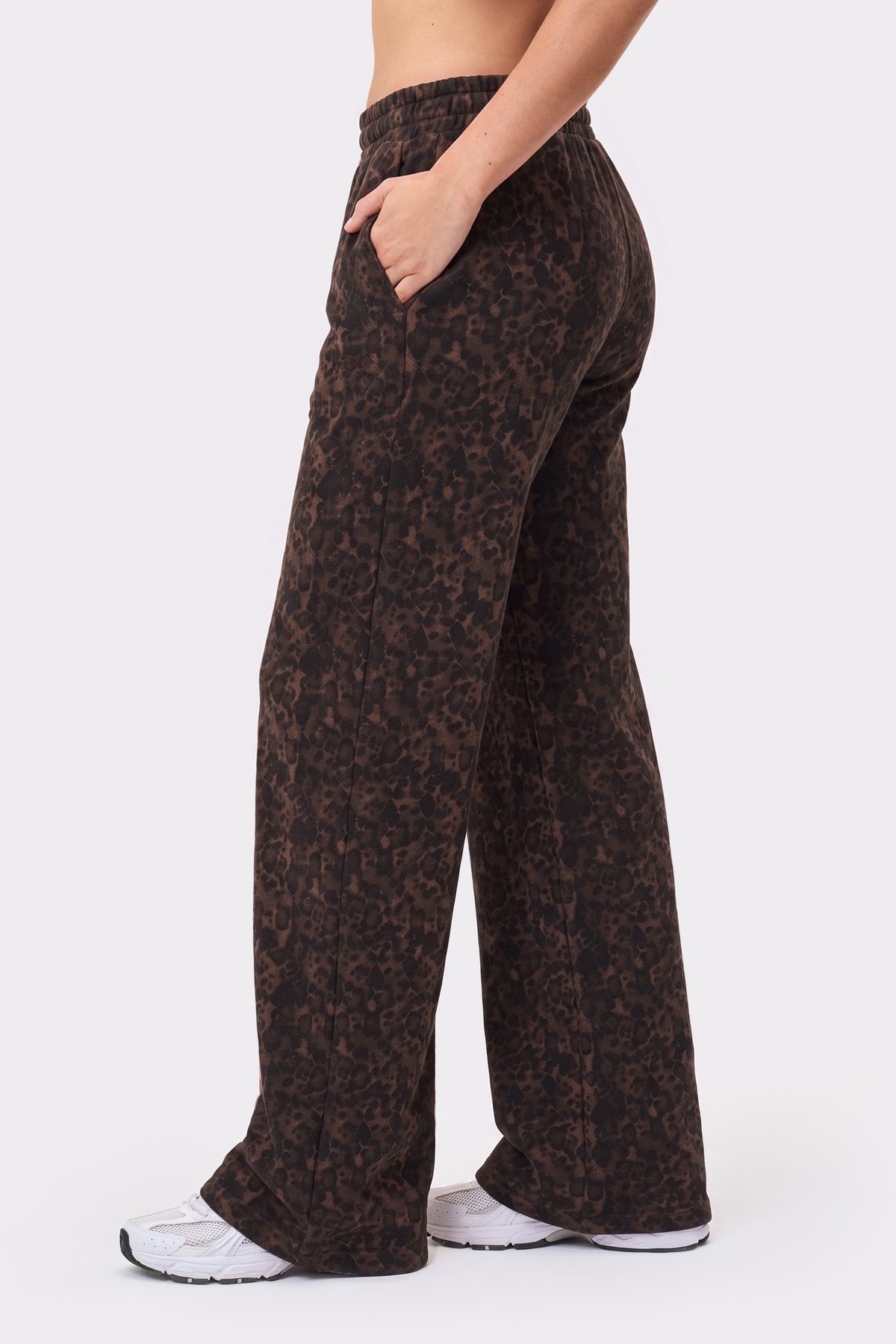 Side view of someone wearing the Relaxed Wide Sweatpants in Dark Leo from Stronger, showcasing straight leg and side pockets.