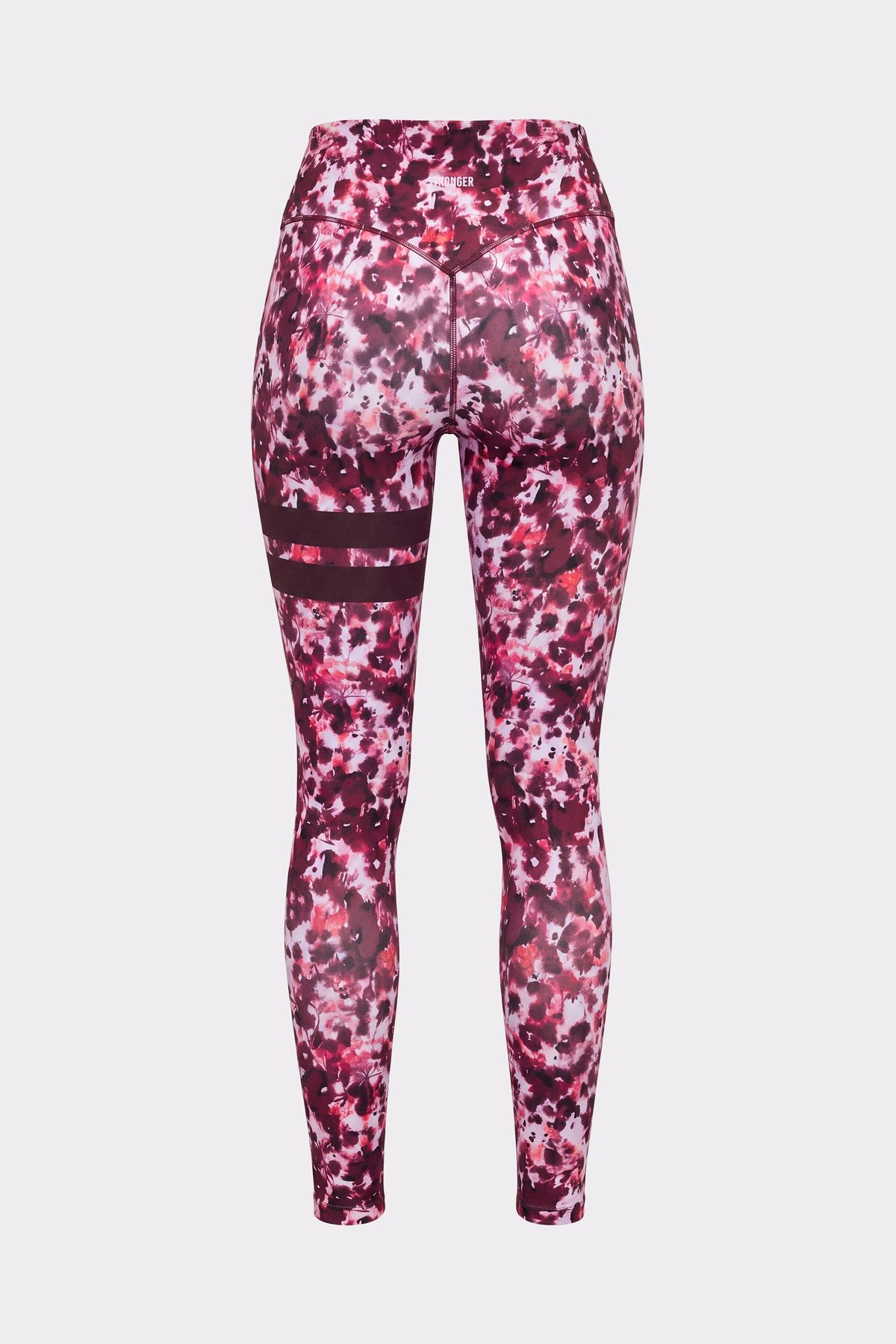 Back of a person wearing the Stronger The Signature One Leggings in Autumn Petals with signature stripes on the left leg.