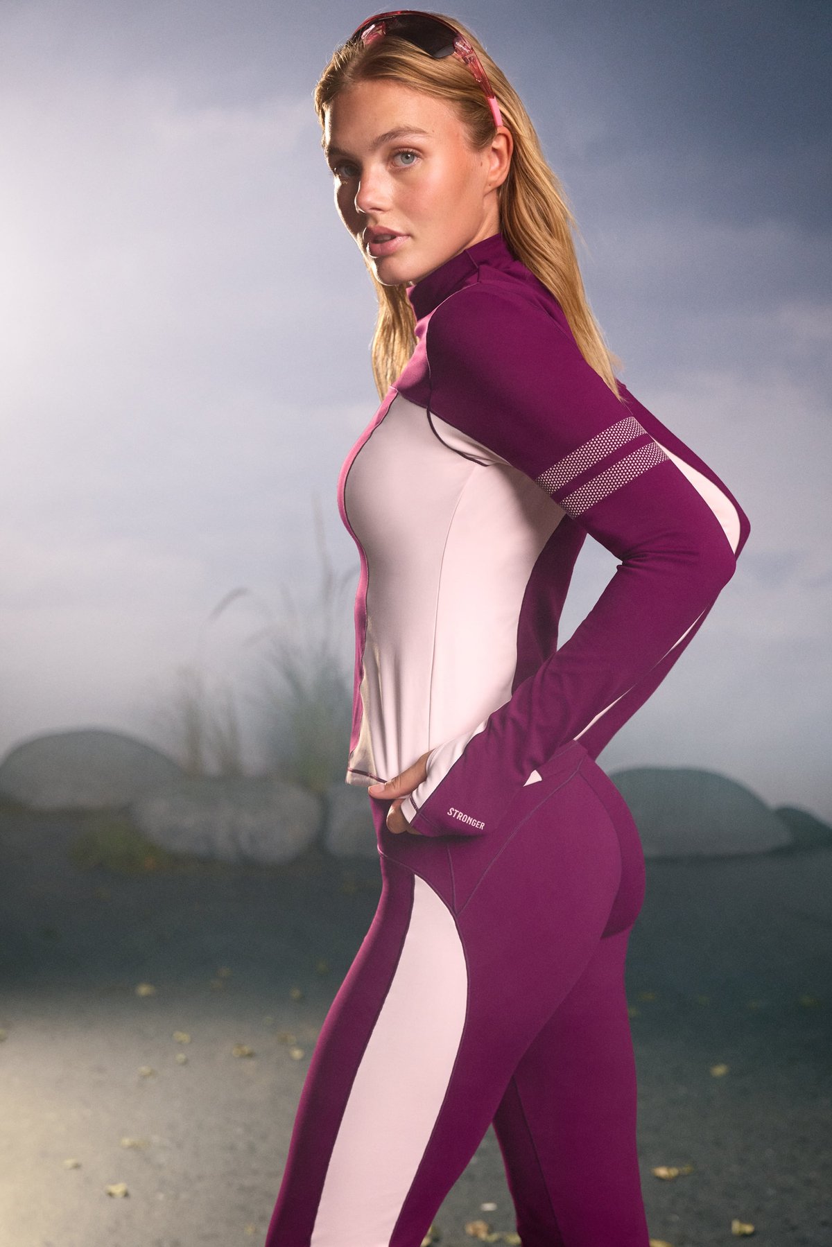 Side view of a model wearing the aubergine purple and pink Thermal Poloshirt from stronger outdoors.