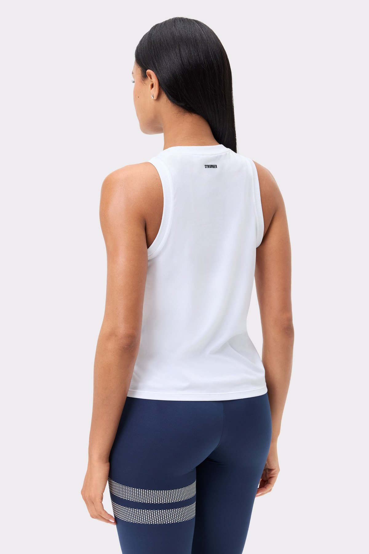 Back view of Stronger's white Relaxed Tank, featuring a small logo at the neck and ribbed trim around the arms.