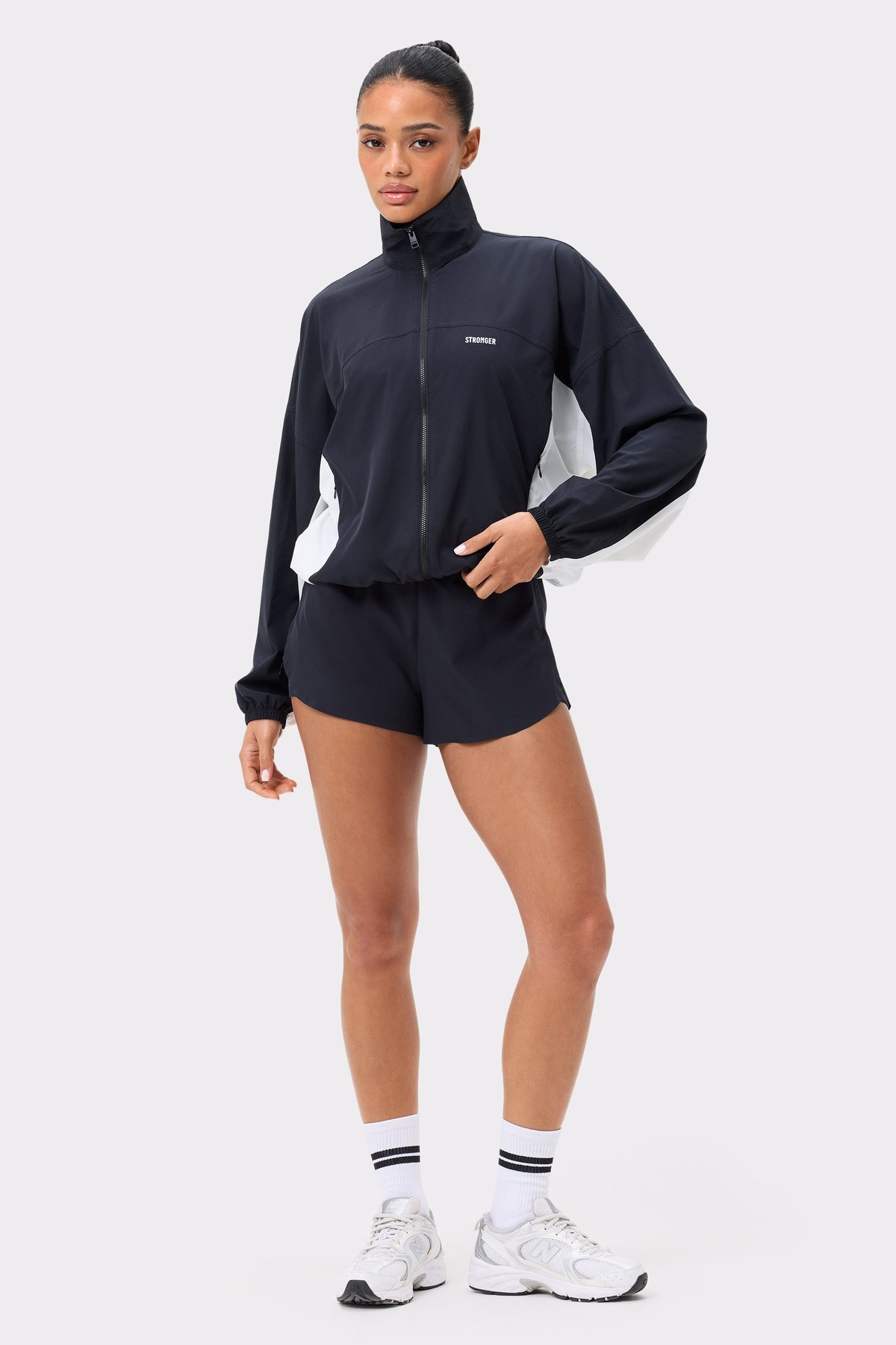 Front view of Stronger's black and white Breezy Woven Jacket, featuring a functional zip and regular fit design.