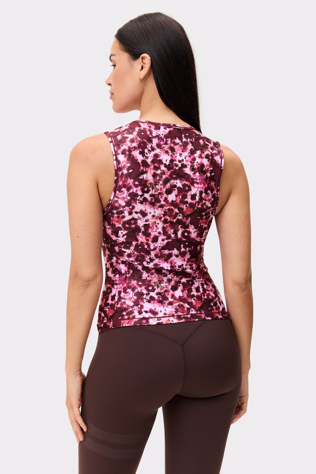 Back view of a model wearing the Stronger Signature Slim Tank Top in the Autumn Petals print.