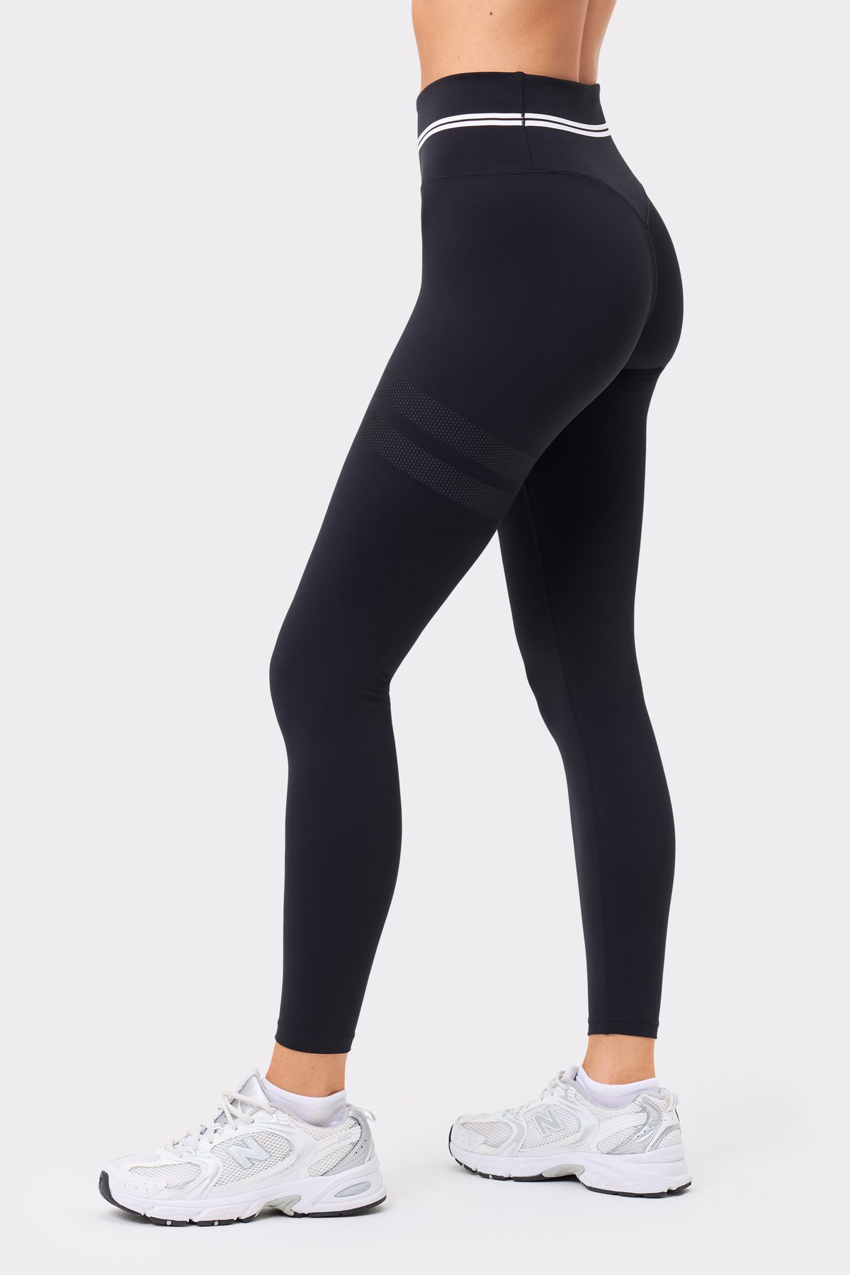 Black Signature Logo Leggings by Stronger, featuring a high-waisted fit and signature stripes on the upper thigh.
