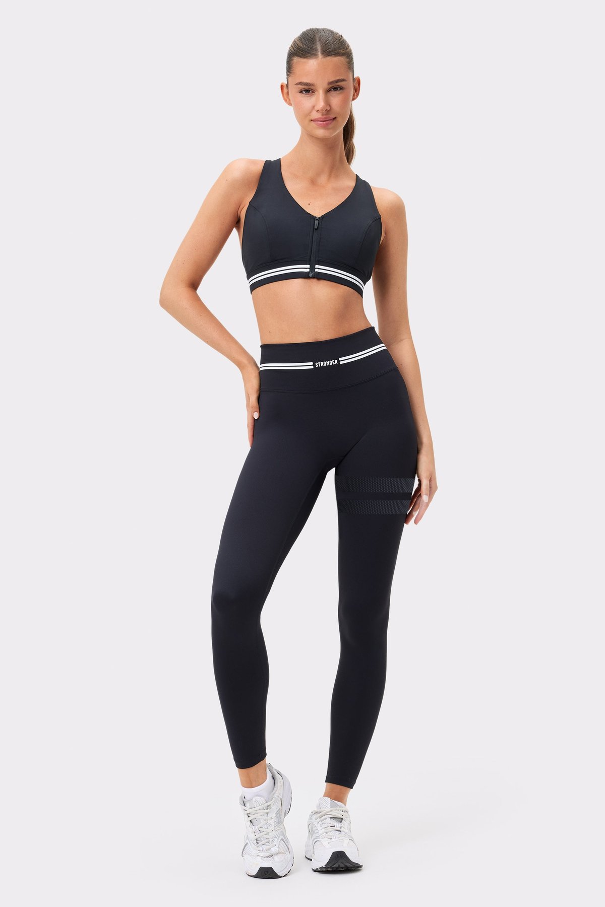 Front view of black Signature Logo Leggings by Stronger, featuring a high waist and signature stripes on the thigh.