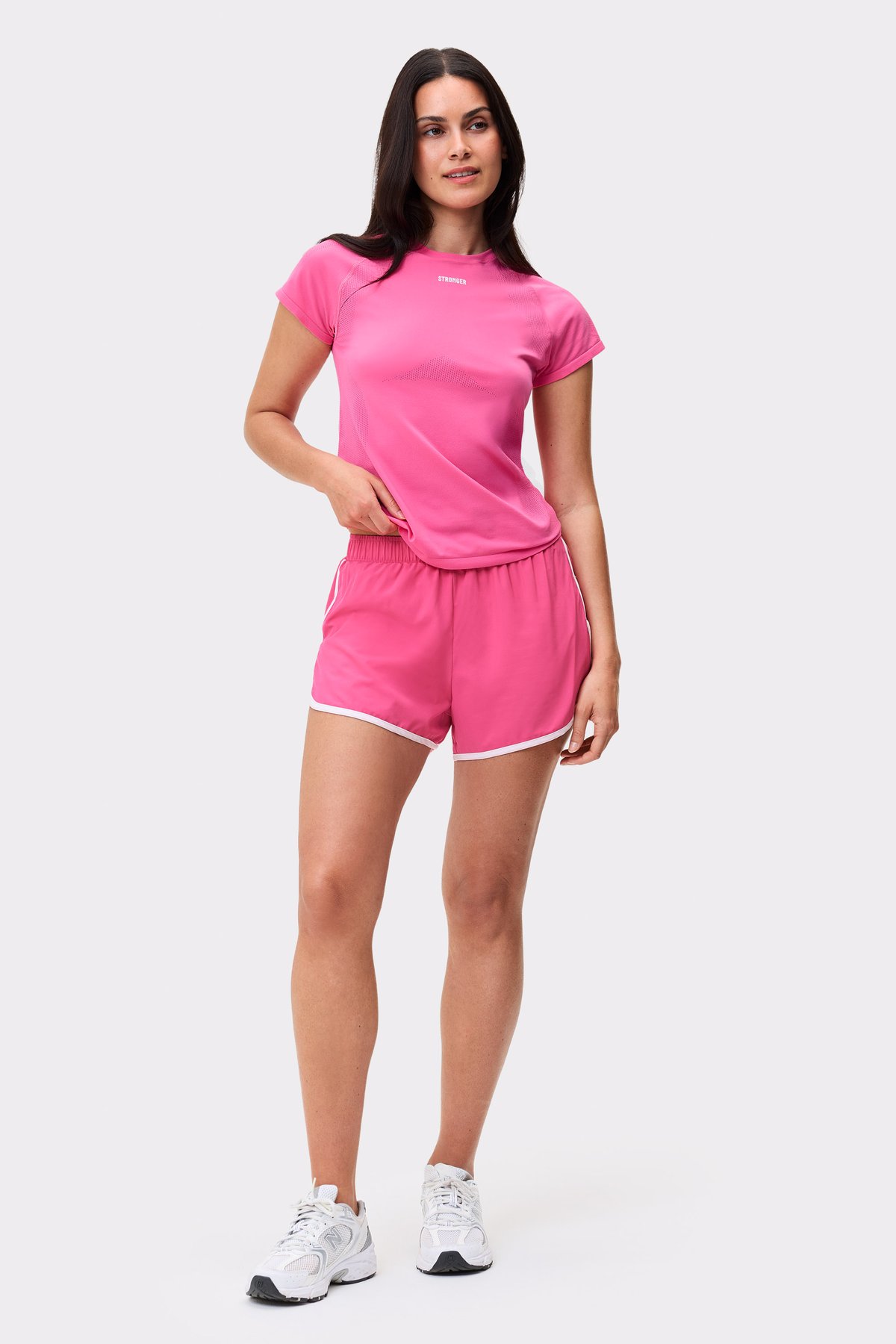 Pink Seamless Performance T-shirt from Stronger, a slim-fit athletic top paired with matching gym shorts.