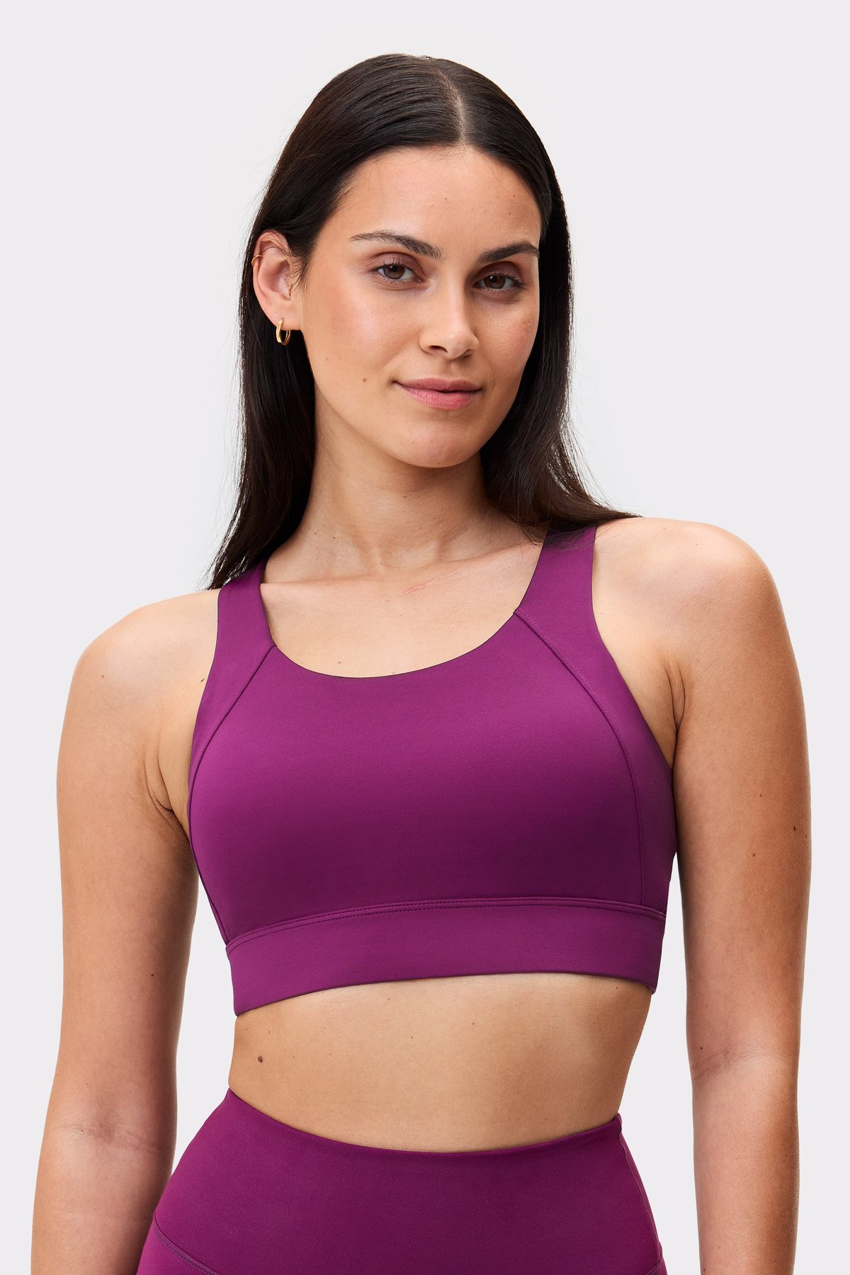Front view of a model wearing the high-support Bounce Sports Bra in dark purple from Stronger.