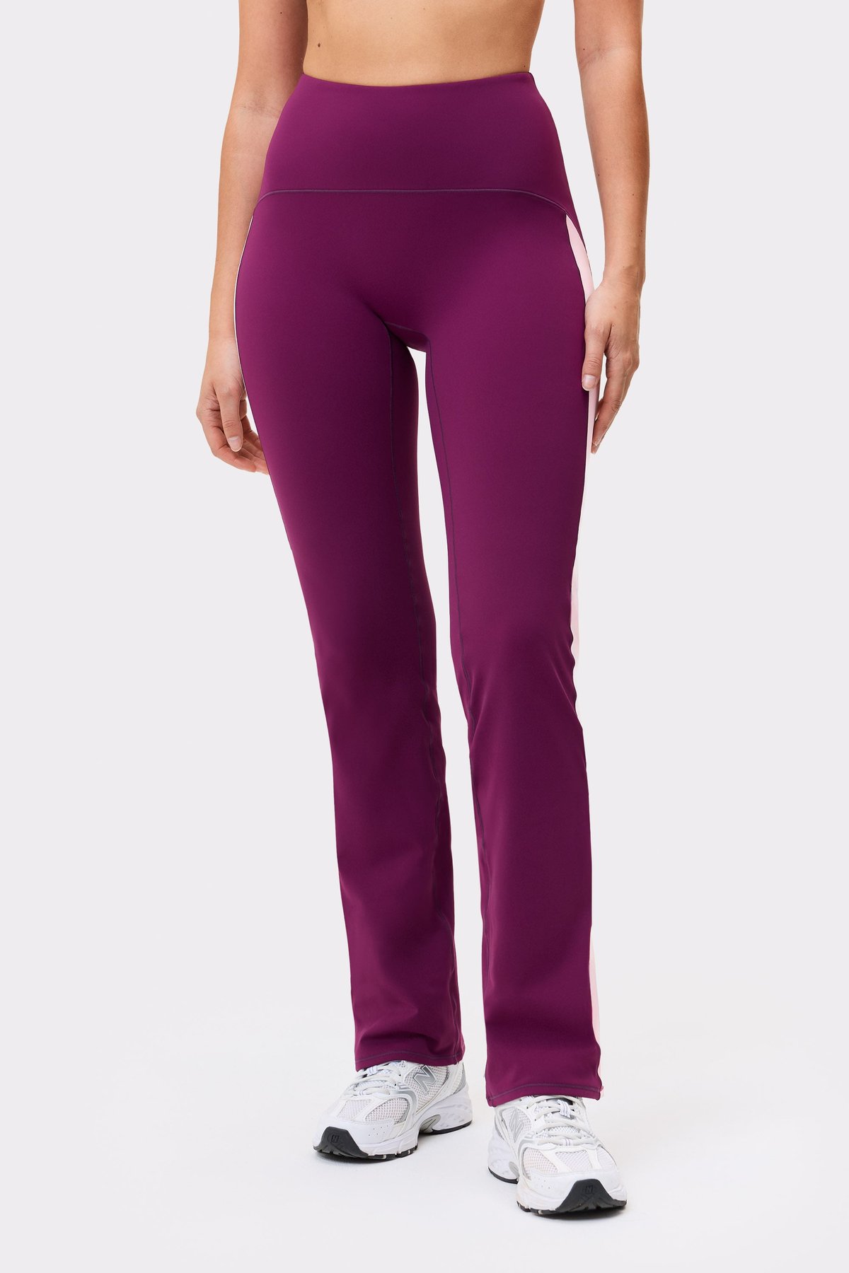 Front view of a model wearing the aubergine purple Thermal Bootcut Pants from stronger, featuring contrast side panels.