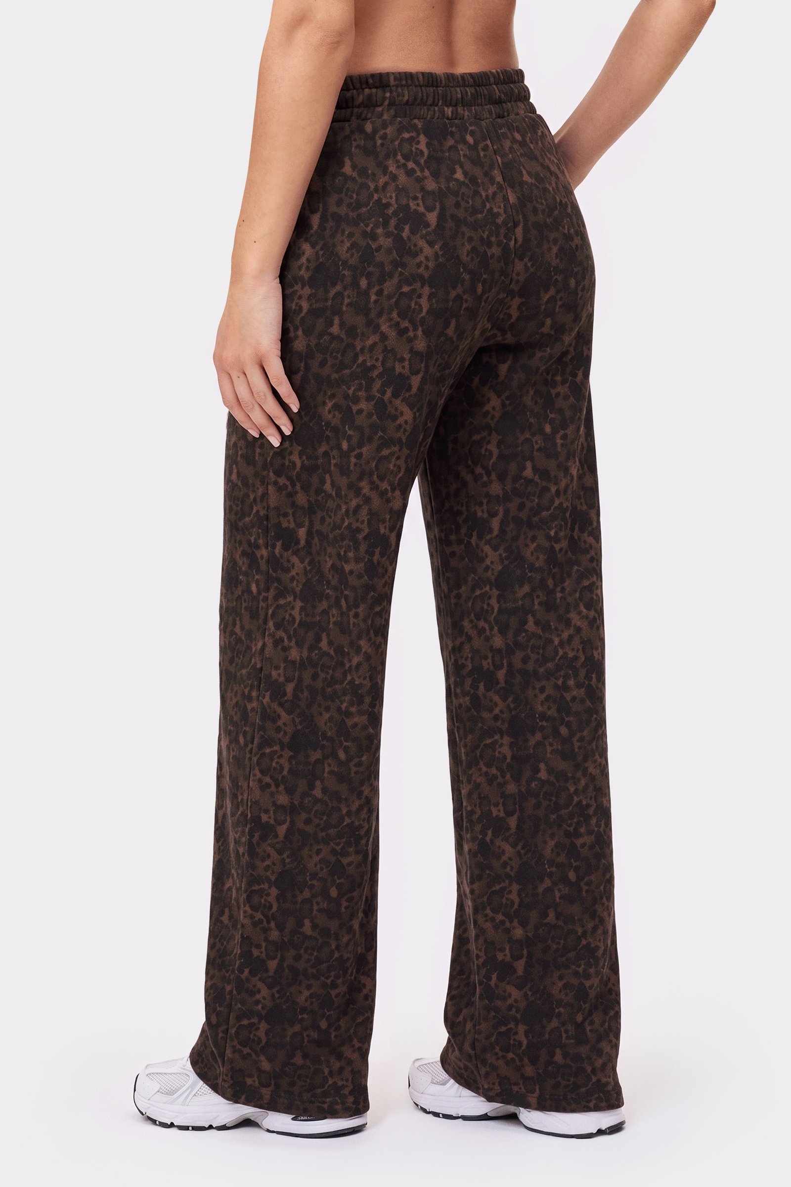Back view of a person wearing the oversized Relaxed Wide Sweatpants in Dark Leo from Stronger.