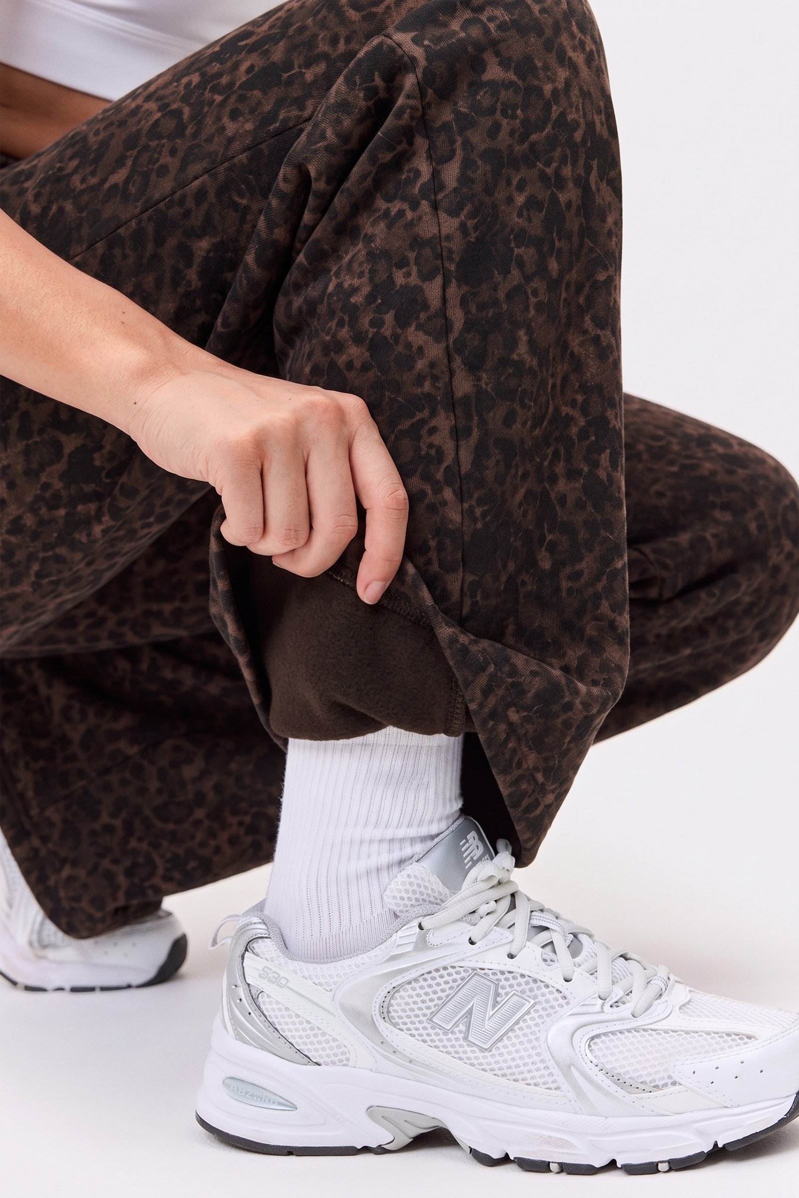 Close-up of a person showing the brushed inside of the Relaxed Wide Sweatpants in Dark Leo from Stronger.