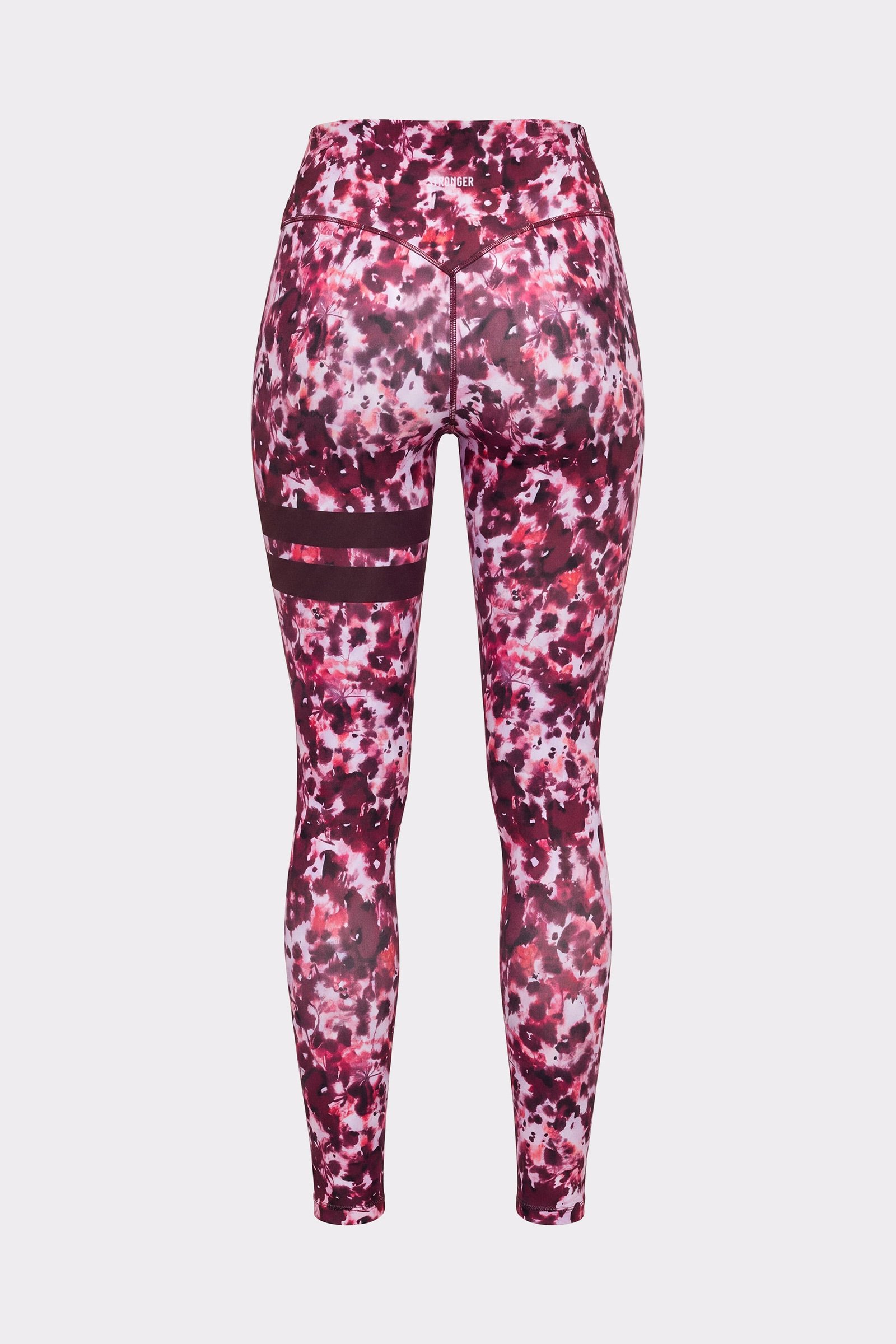 Back of a person wearing the Stronger The Signature One Leggings in Autumn Petals with signature stripes on the left leg.