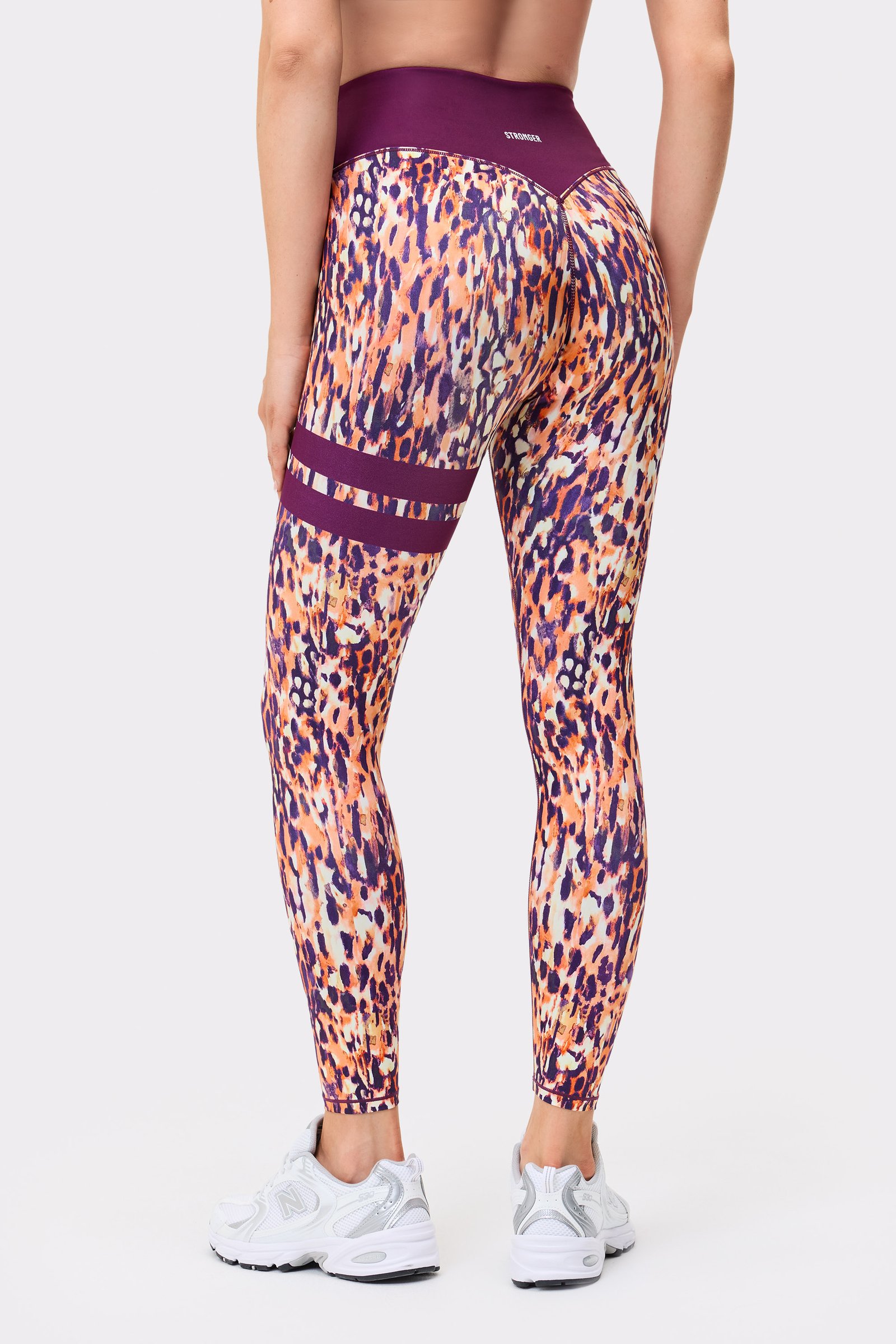 Back view of a person wearing Stronger The Signature One Leggings in Malibu Milk Print with signature stripes.