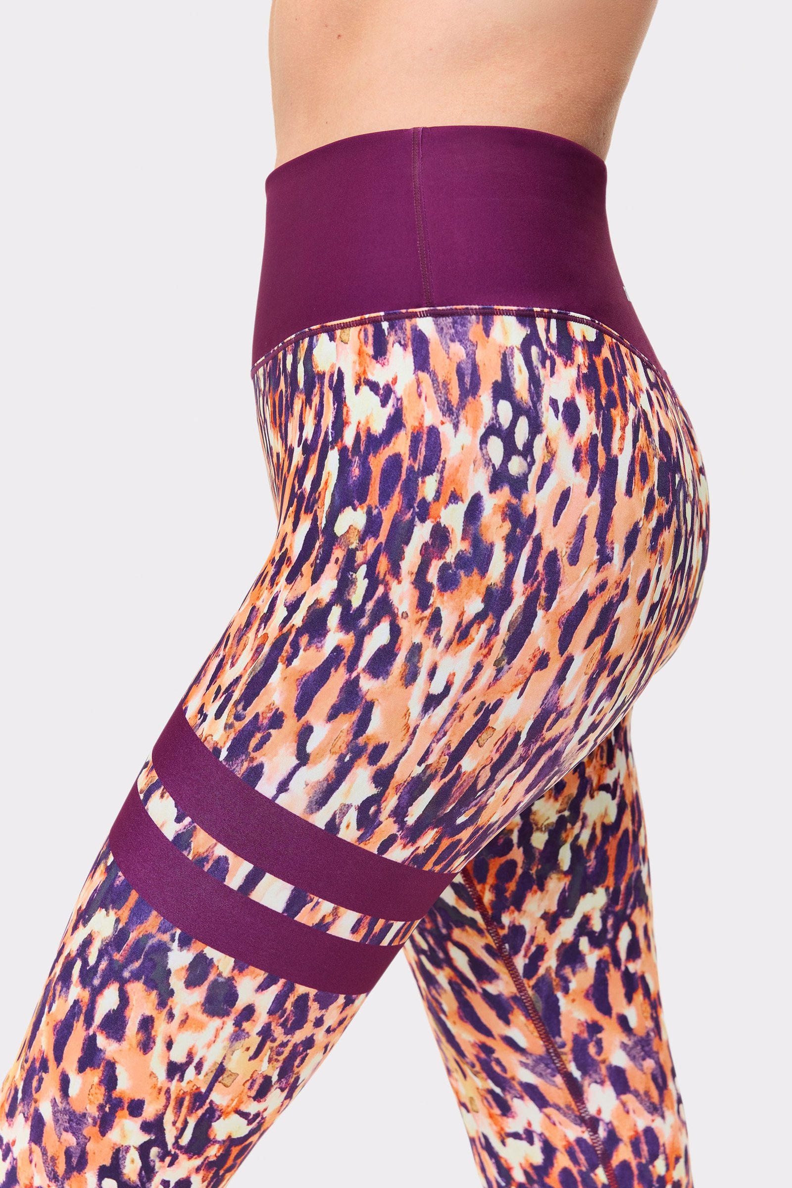 Close-up of Stronger leggings in Malibu Milk Print, showing the high waistband and signature leg stripe details.