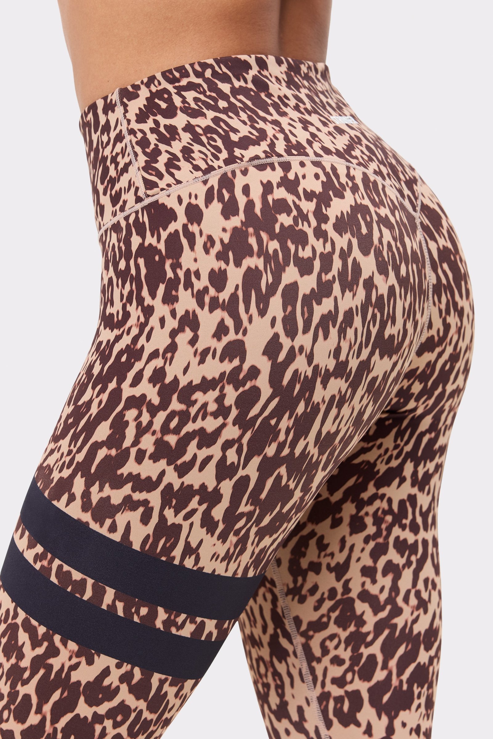Stronger's The Signature One Leggings in Leo Rush print, showing the light brown leopard pattern and signature stripes.