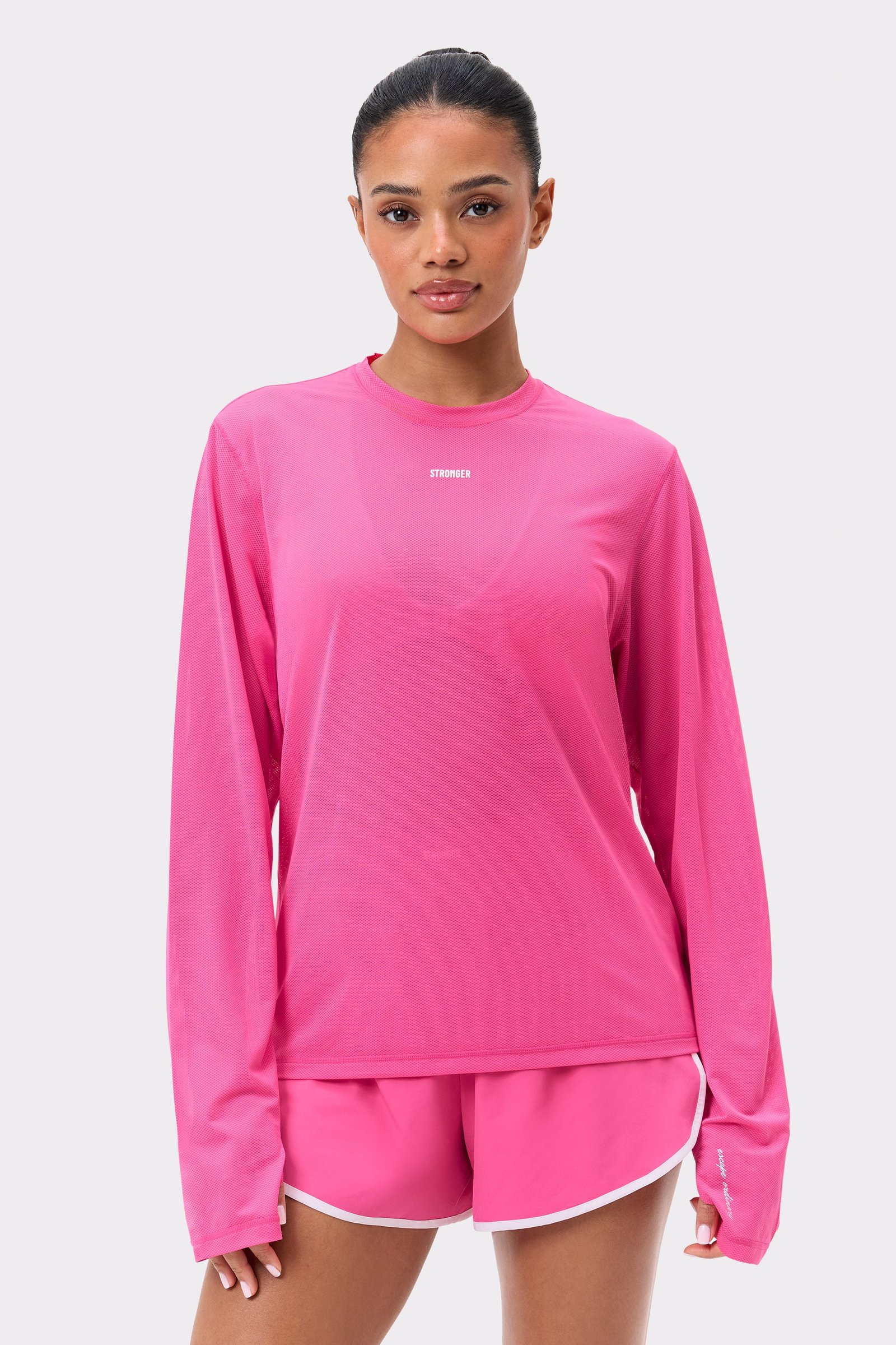Pink Mesh Running Long Sleeve by Stronger, featuring a loose fit and breathable mesh fabric for running sessions.