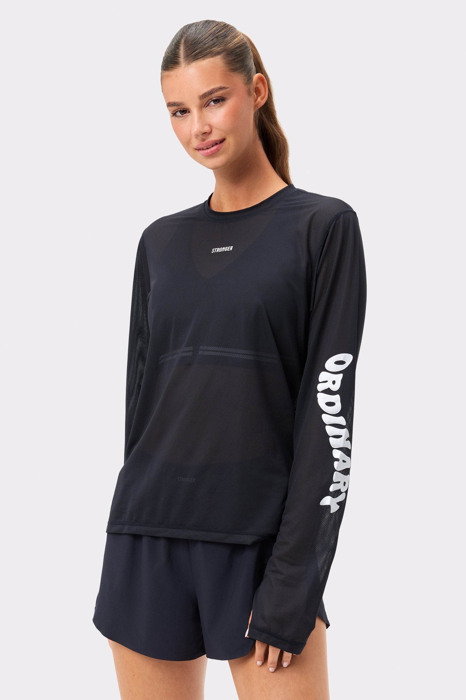 Stronger black Mesh Running Long Sleeve with a loose fit, breathable mesh fabric, and white graphic on the sleeve.
