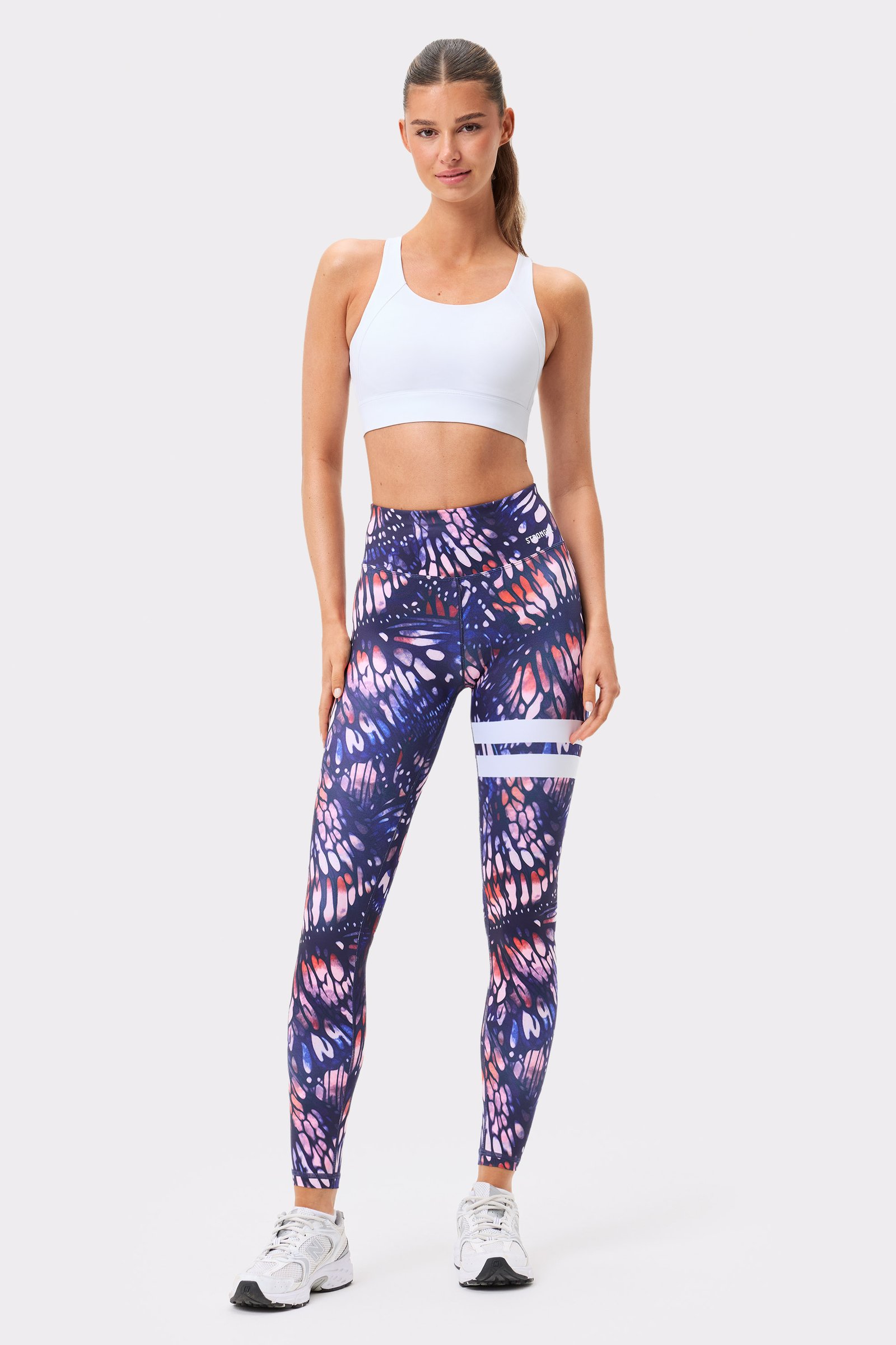 Stronger's dark pink butterfly print Explore Printed Leggings with a high waist and iconic white stripes.