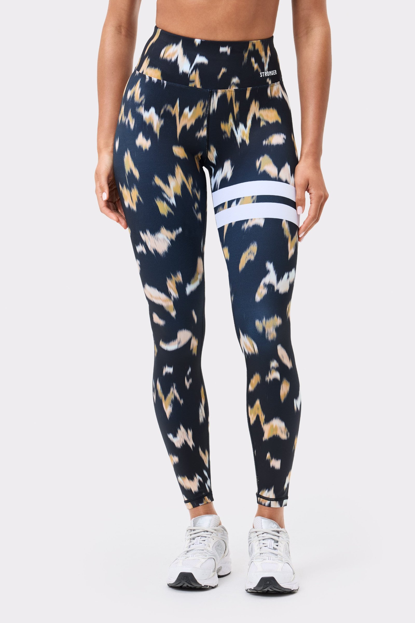 Front view of Stronger Explore Printed Leggings in Savannah Print, showing the high waist and signature white stripes.