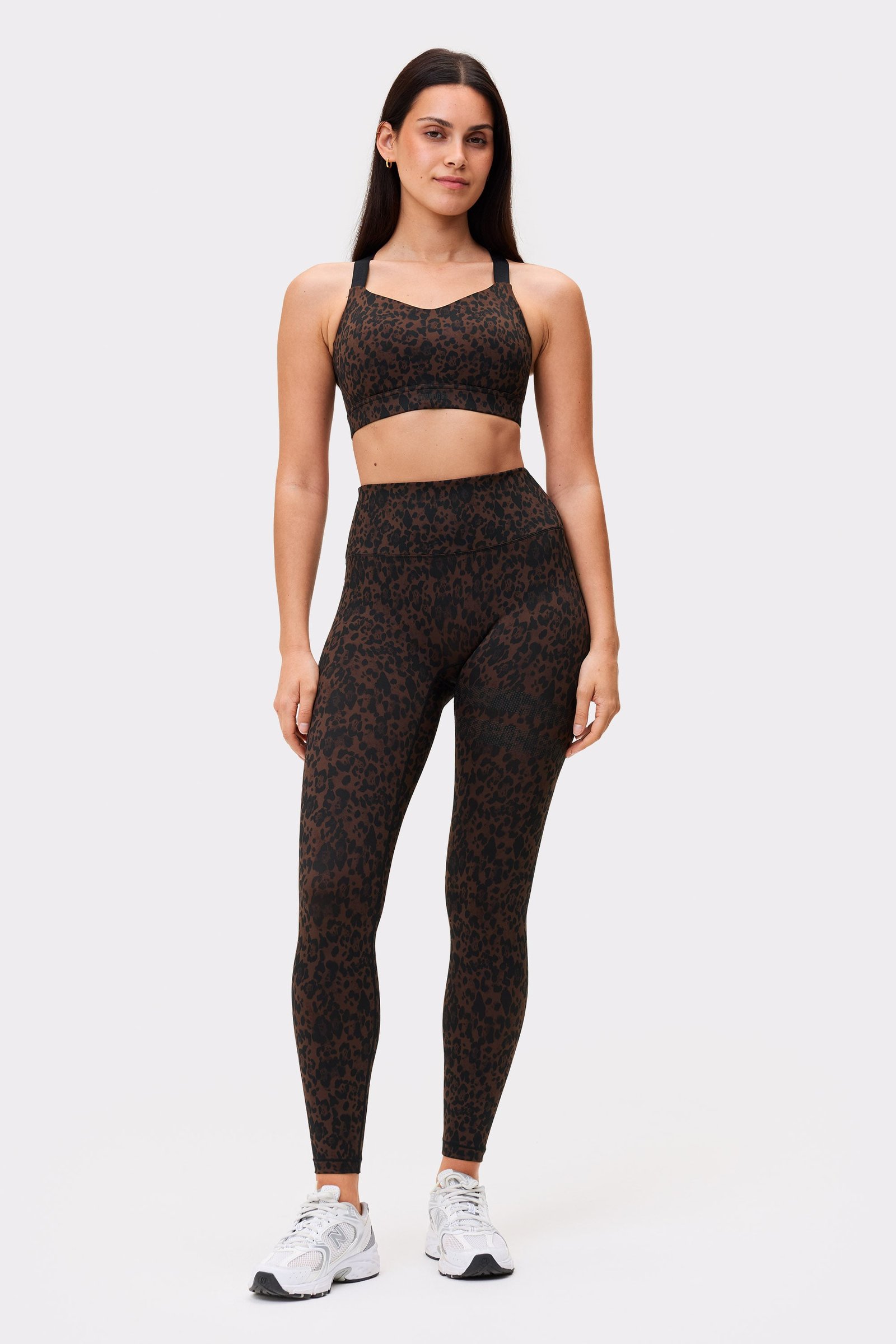 Front view of a model wearing the Power Sports Bra and leggings in Dark Leo from Stronger, showcasing the high-support fit.