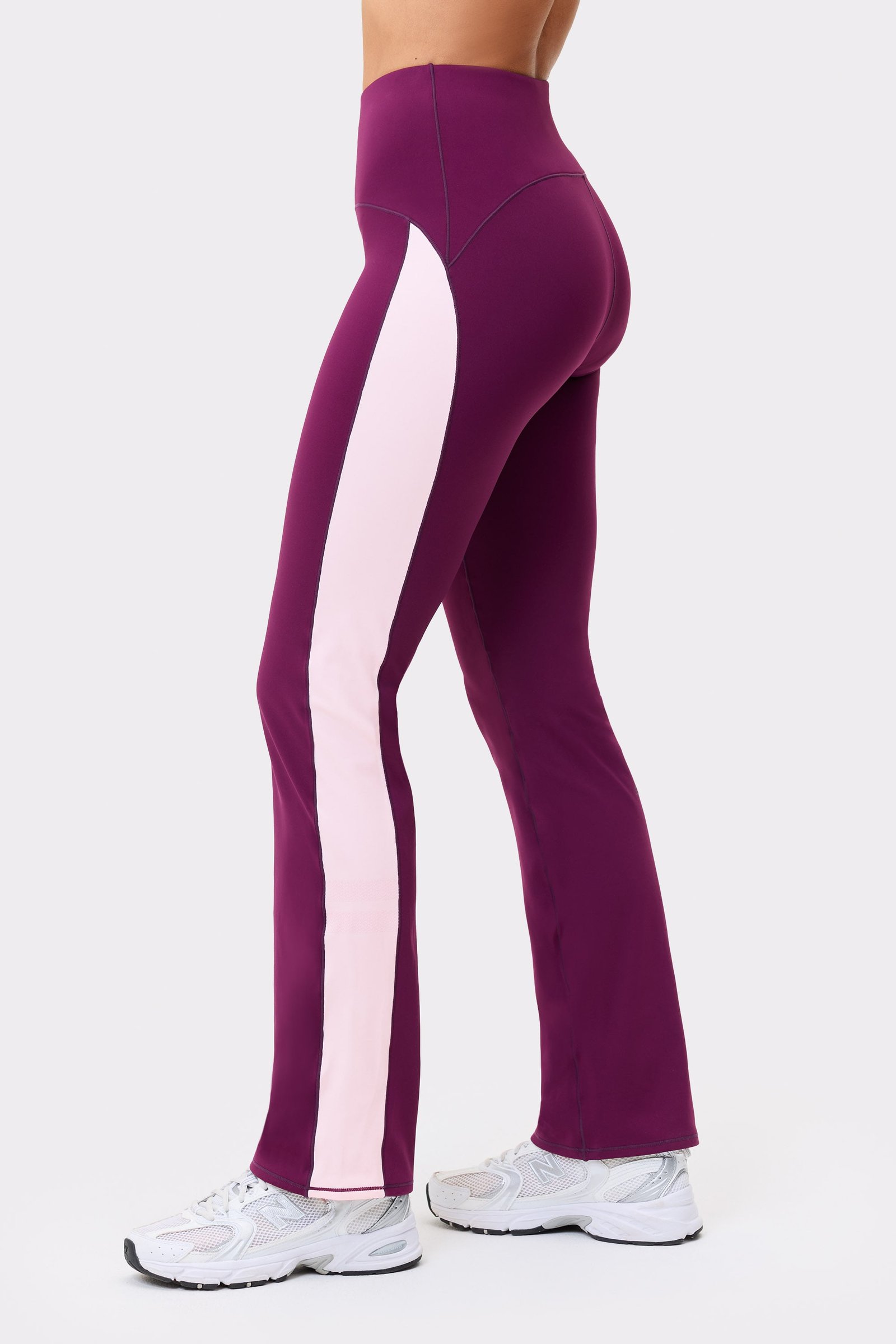 Side view of Thermal Bootcut Pants in aubergine purple from stronger, showing a contrasting side panel.